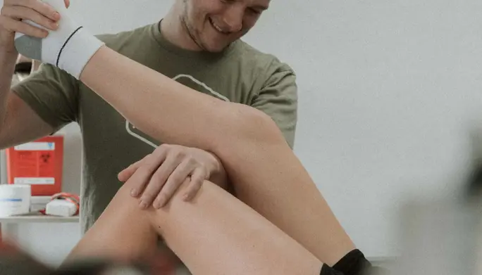 sports Physical therapy helping stretch the knee